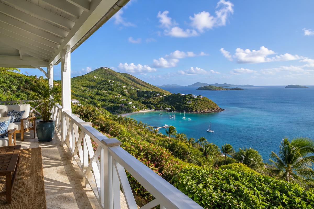 Caribbean villa with a veranda overlooking Carenage Bay, Canouan, with green hills and the Grenadines beyond; illustrative, not a photograph of the listed property